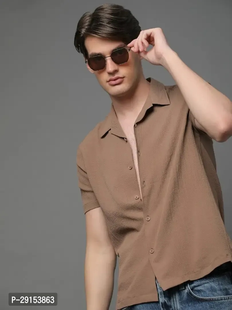 A man standing and wearing a half sleeves casual brown shirt. classyfad best t shirt store.
