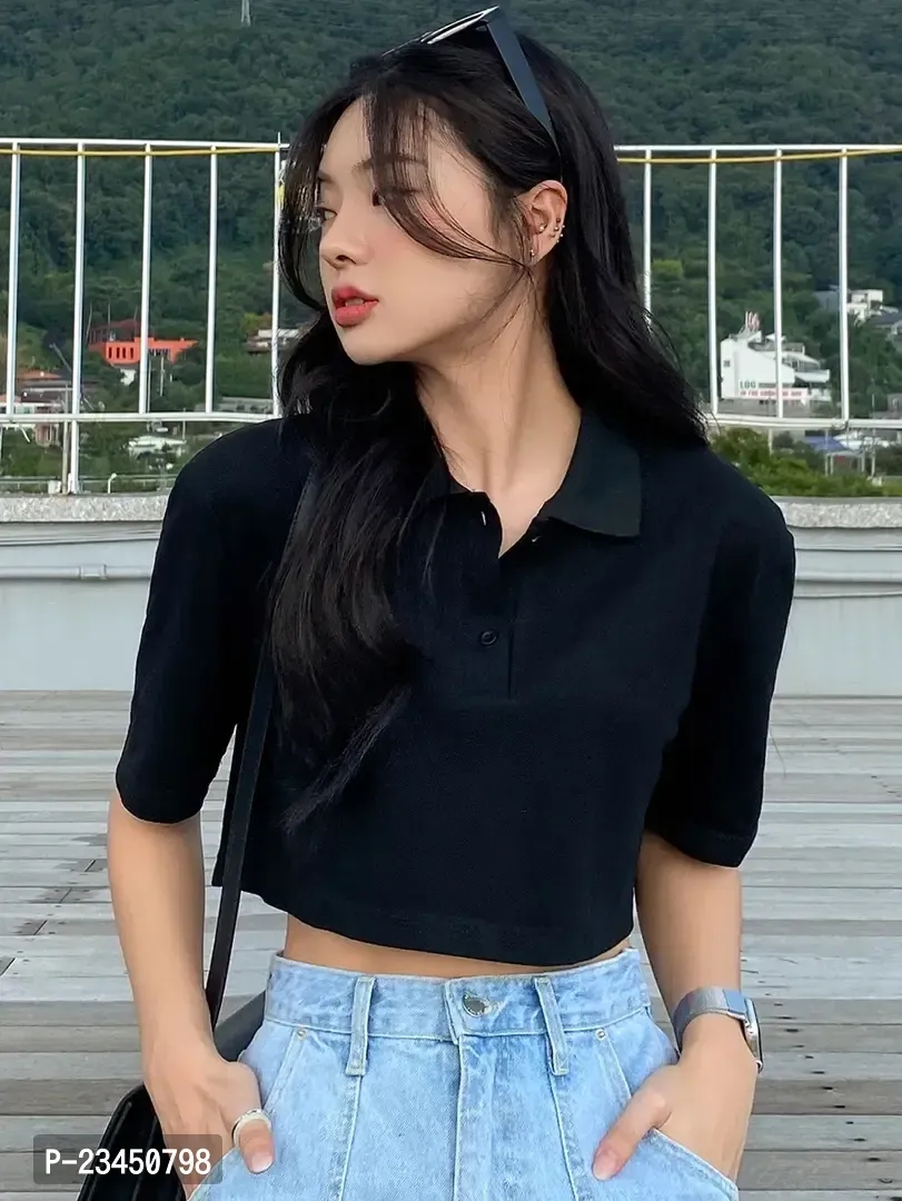 A women standing and wearing a black color shirt type top. classyfad best t shirt store.